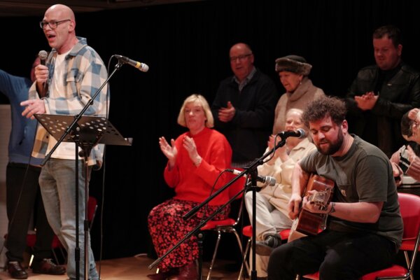 Rob Gee on the mic and members of The Comedy Asylum