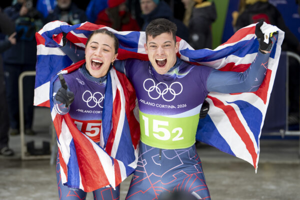 Matt Weston of Team GB celebrates with Tabitha Stoecker  after his run in the Mixed Skelton Event at the Cortina Sliding Centre during Milano Cortina 2026 Winter Olympics 2026.