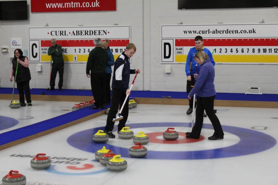 Club members in action at Curl Aberdeen, with young and older curlers competing side by side. The club has over 600 members aged eight and over, and has hosted the European and World Curling Championships. Image credit: Curl Aberdeen