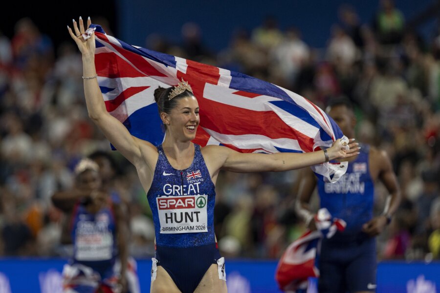 An athlete in lit that says 'Great Britain' celebrates holding a union jack.