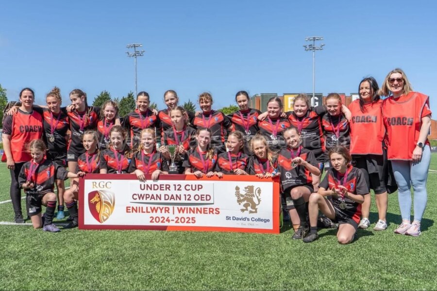 A group of young rugby players posing for a photo.