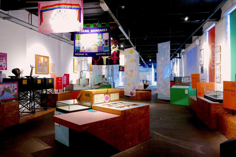 Inside The Peace Museum, a selection of peace banners hang from the mill's high ceilings