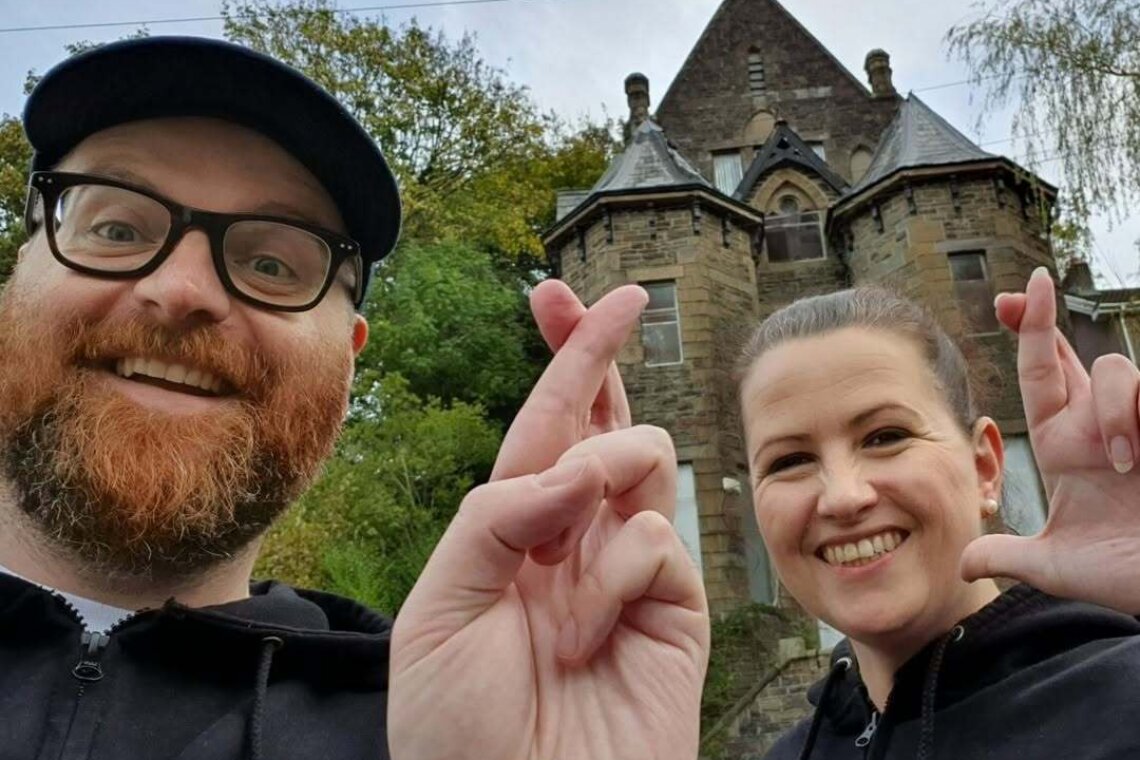 Two people with their fingers crossed.