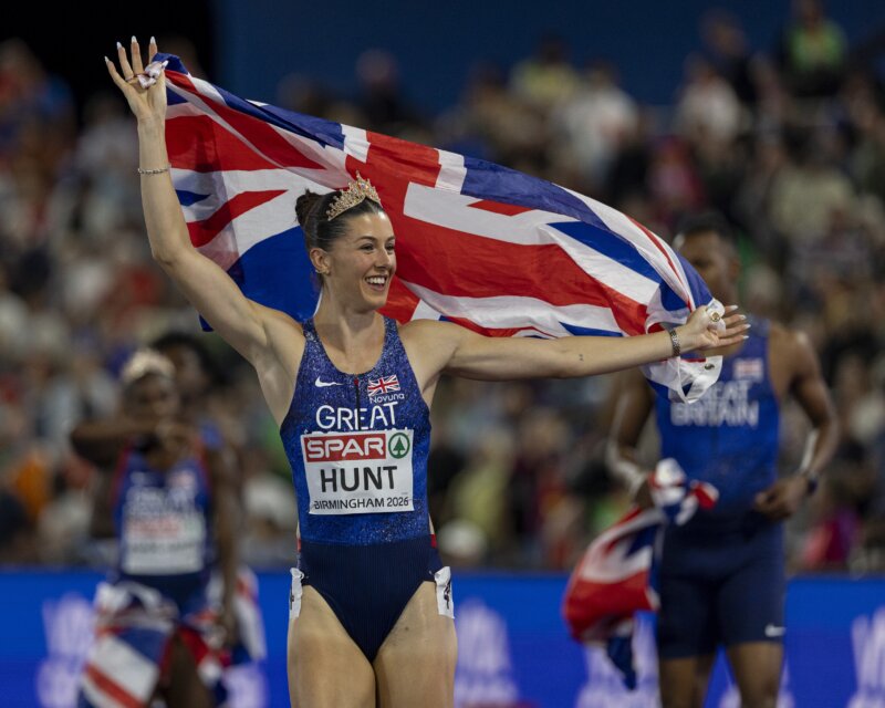 An athlete in lit that says 'Great Britain' celebrates holding a union jack.