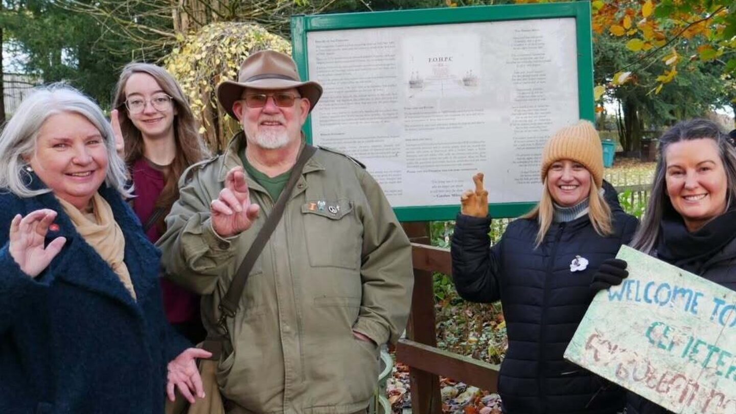 A group of people doing crossed finger selfies