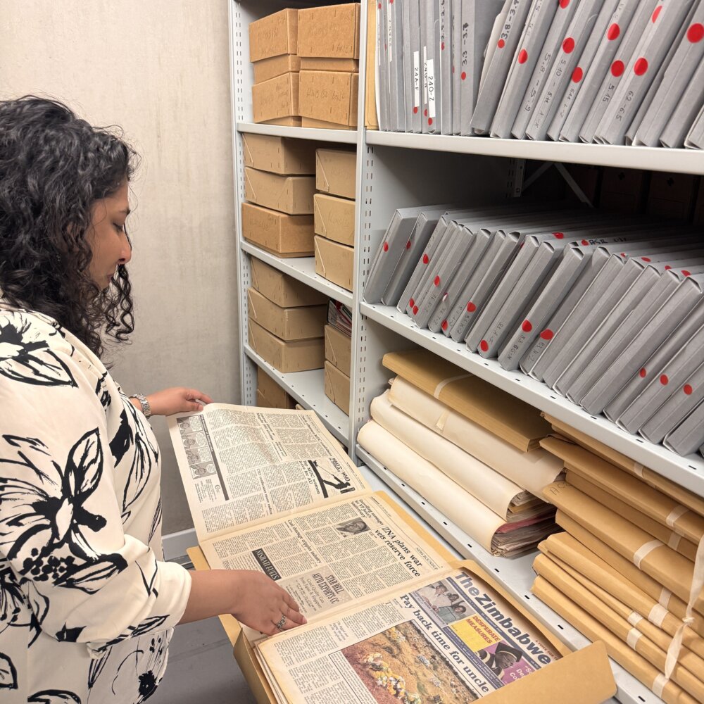 A person in a library with archival materials.