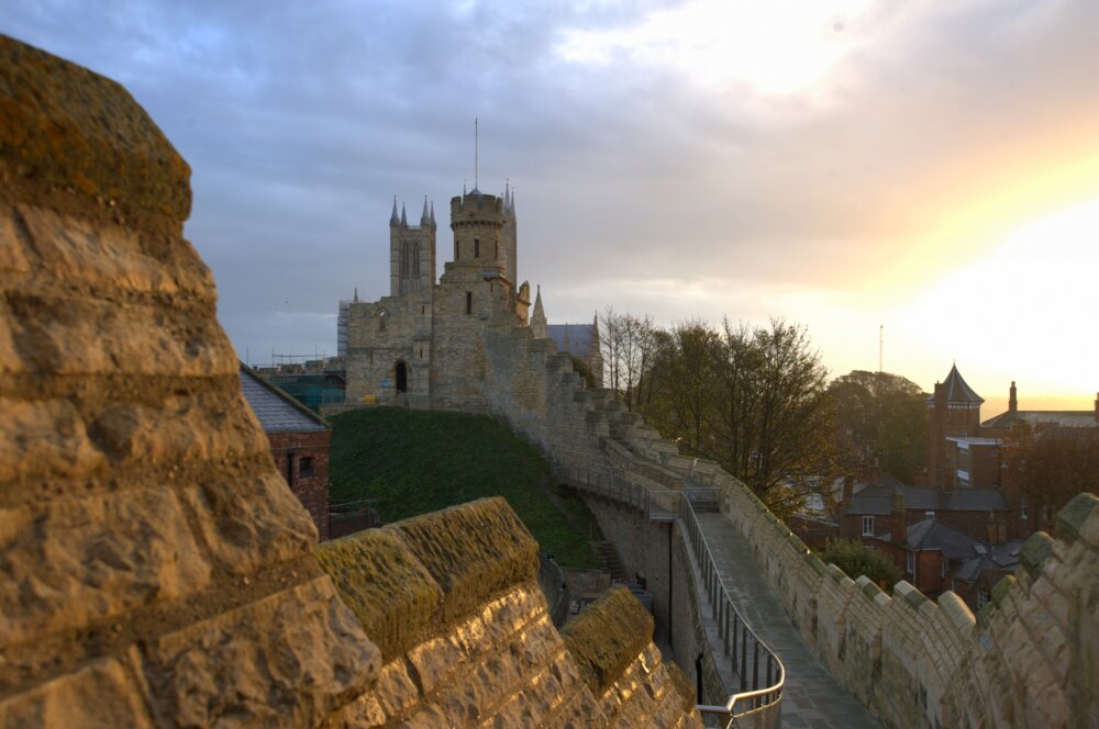 Lincoln Castle pictured from the high walkway around the castle keep, at sunset.