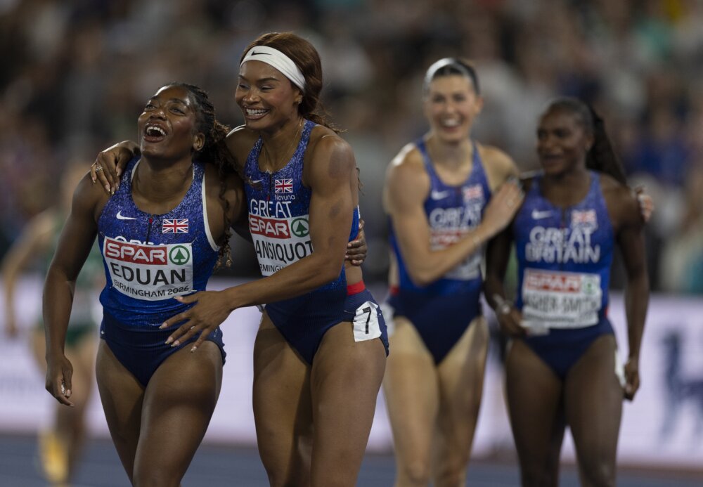 Two athletes in kit that says 'Great Britain' are celebrating.