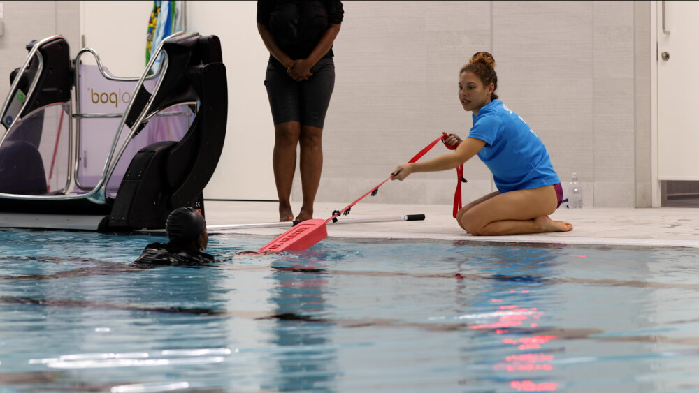 Helping someone learn to swim at the Black Swimming Association