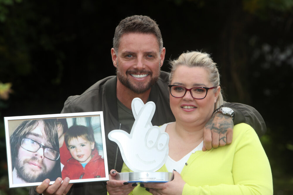 Keith Duffy and Julia McKeever holding photoframe of Julia's late son, Luke.