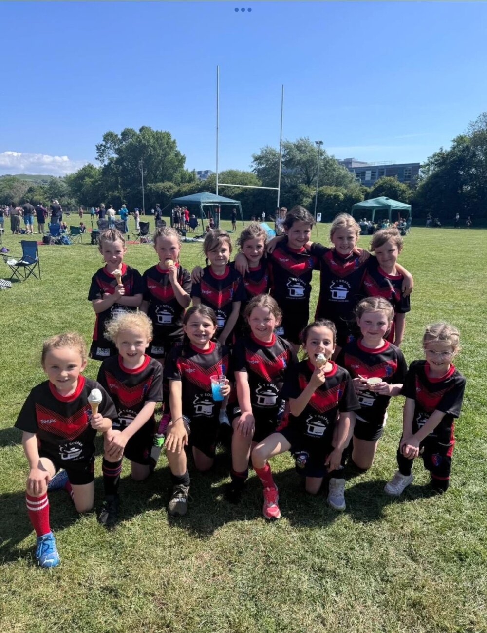 A group of young rugby players pose for a photo.