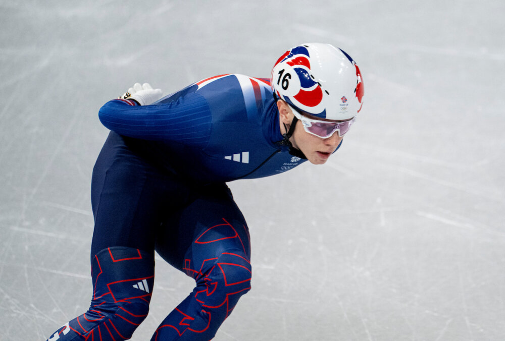 Niall Treacy competing in a short track speed skating race for Team GB.