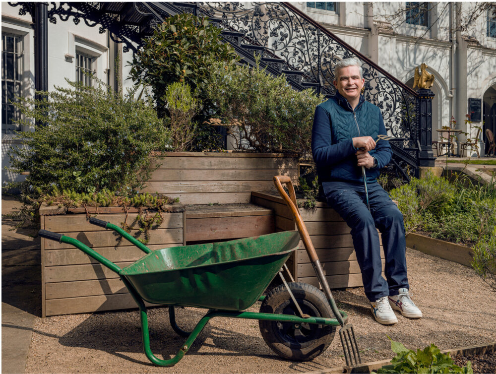 A man, Tom Devlin, in a garden at Strawberry Hill House.