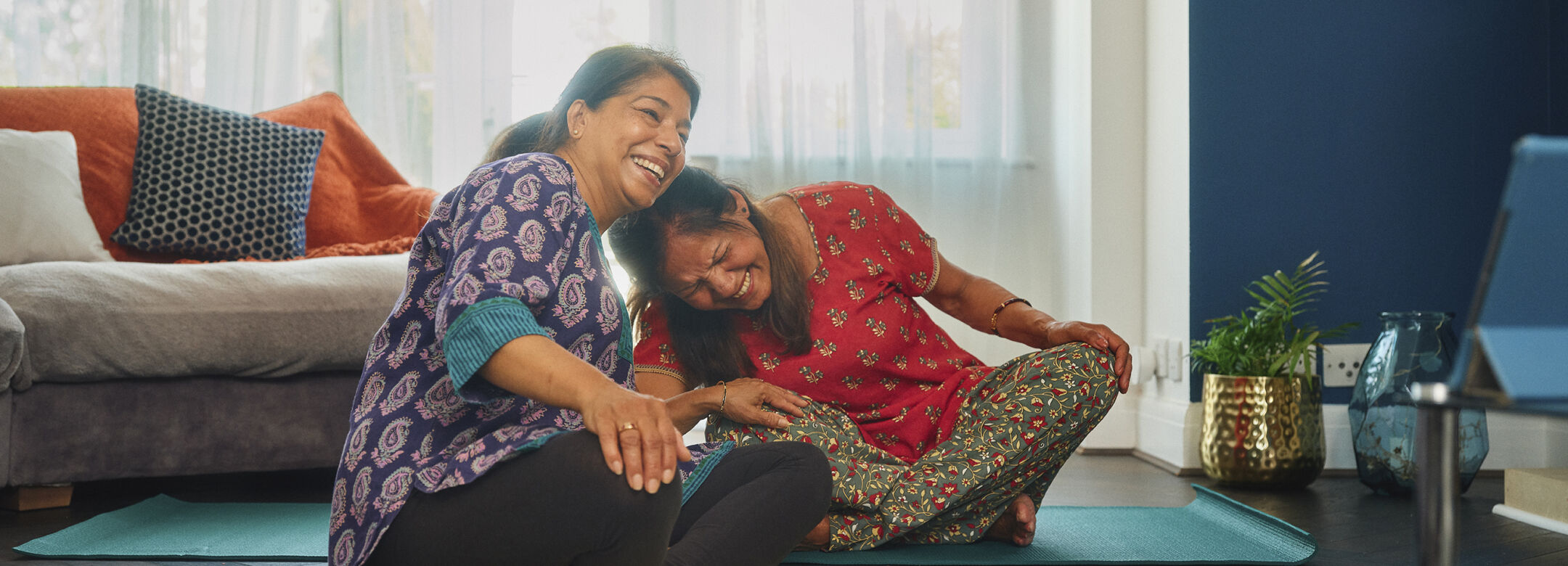 Two women taking part in yoga.