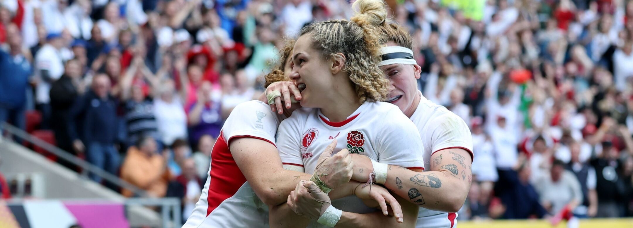 Ellie Kildunne of England celebrates scoring her team's fourth try with team mates Megan Jones and Abby Dow during the Women's Rugby World Cup 2025 Semi Final match between France and England.