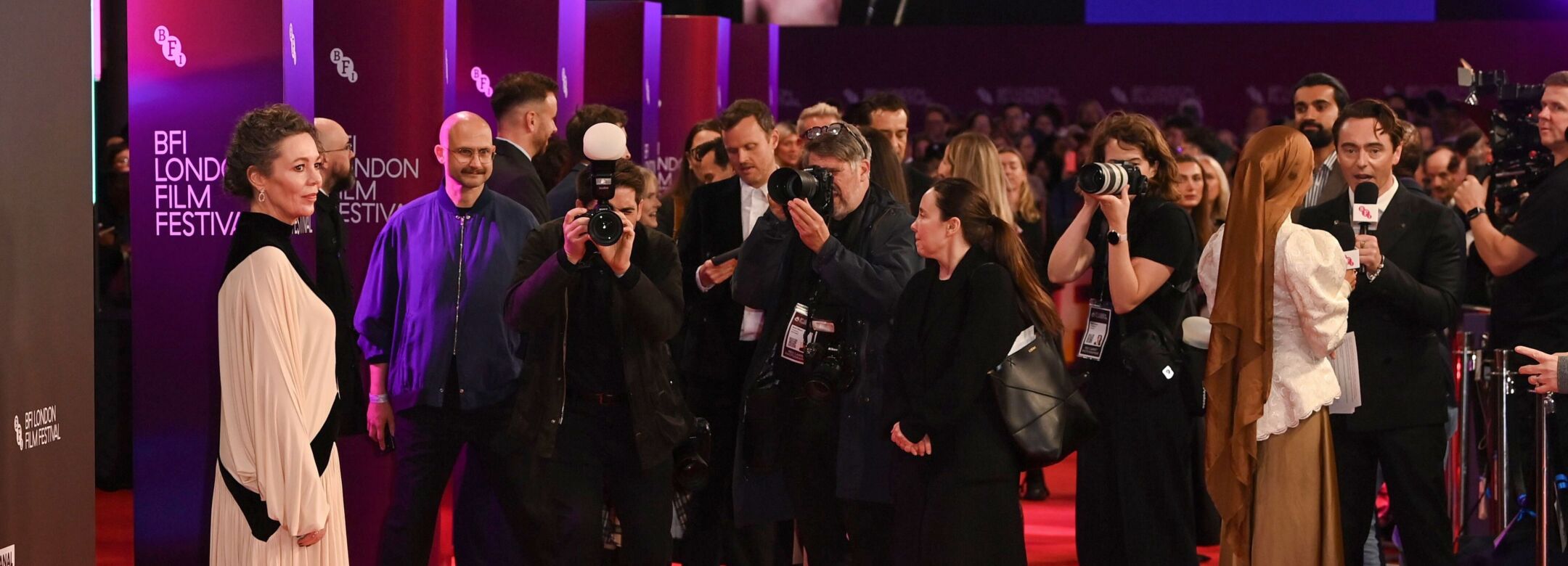 A person is photographed on the red carpet.