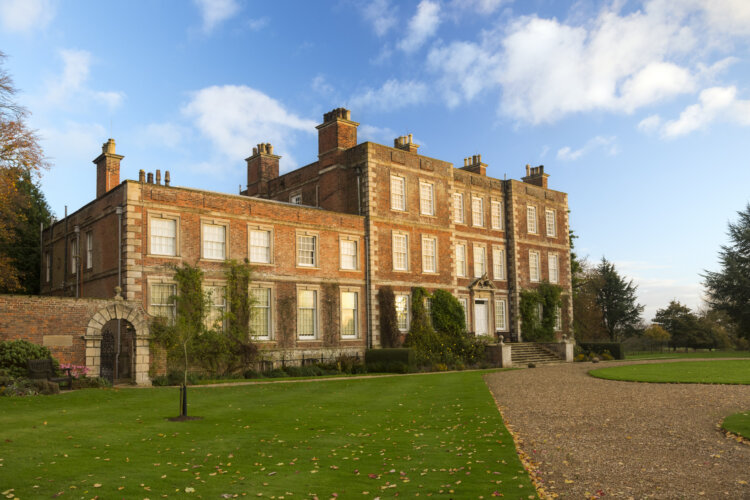 A large old house with lots of rectangular windows