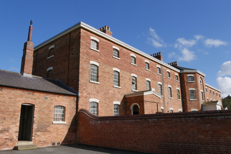 A large red brick building with many windows
