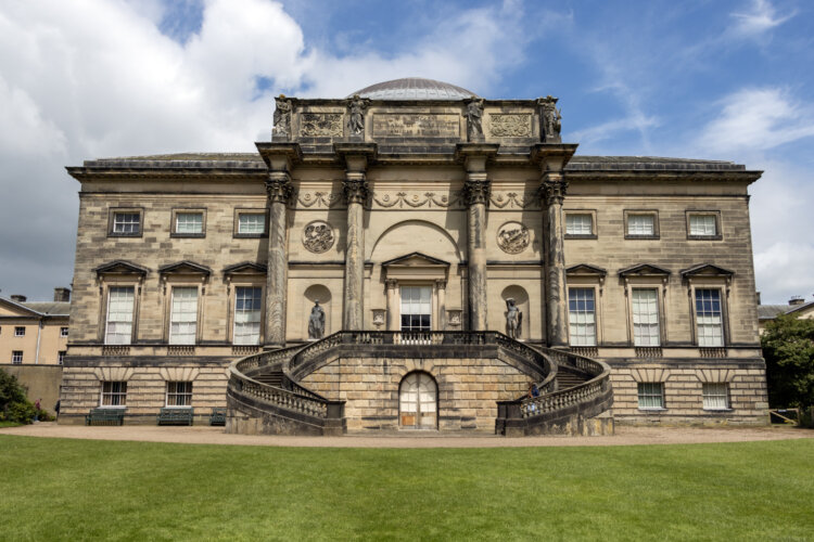 A large sprawling mansion with two staircases curling round and into the garden