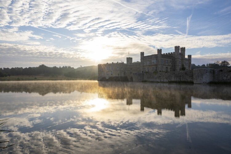 View of Leeds Castle at sunrise across the moat.