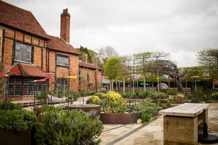 The image shows the main entrance garden of New Place Gardens.
