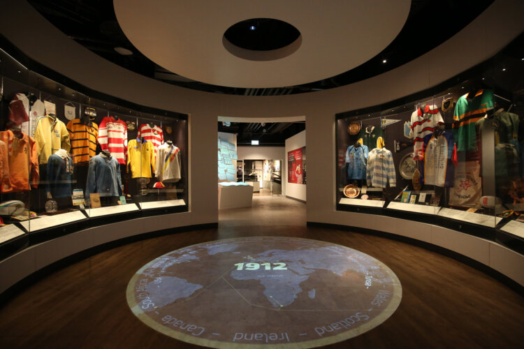 Circular room in the World Rugby Museum with showcases of rugby jerseys from around the world.
