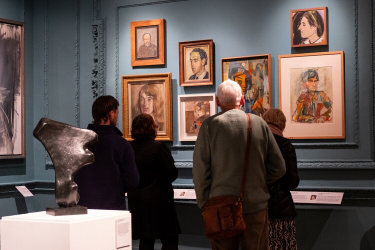 A group of people looking at the collection’s gallery in Abbot Hall.