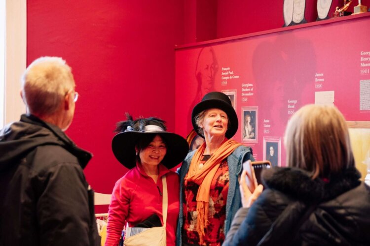 A family wearing vintage hats enjoying the Buxton Crescent Experience