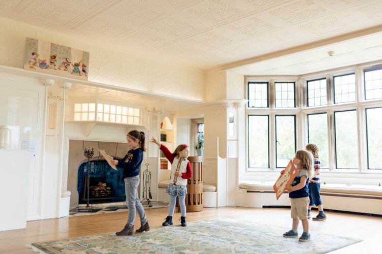 Four children in the White Drawing Room at Blackwell – the Arts & Crafts house.