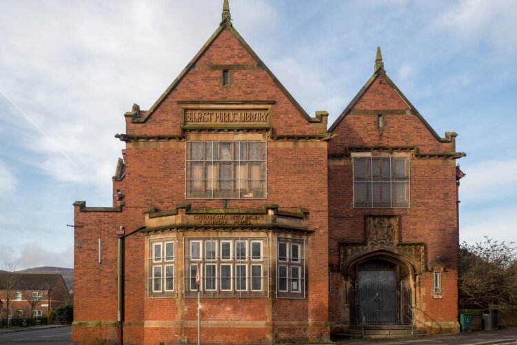 a beautiful old brick building with two pointed turrets