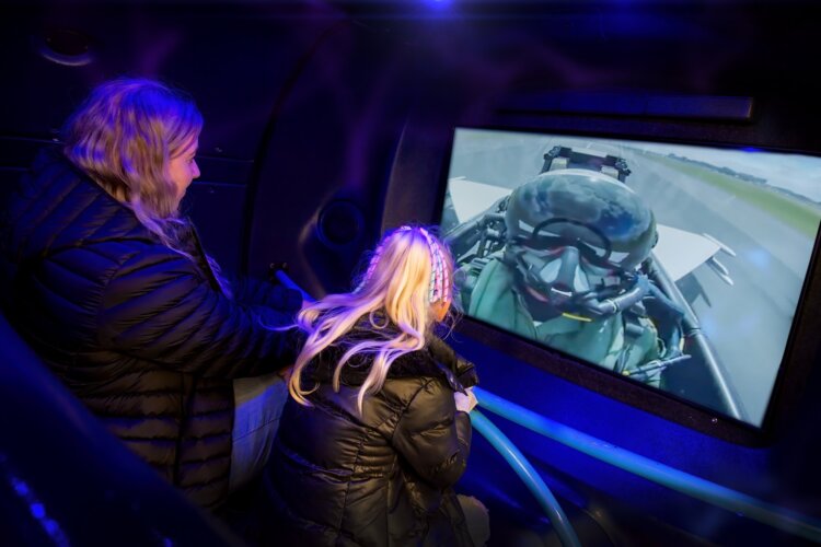 Visitors on Flight Simulator Ride at RAF Museum London