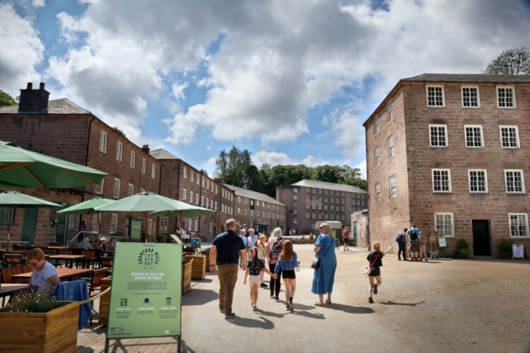 Image of Mill Yard with welcome signs, families and visitors