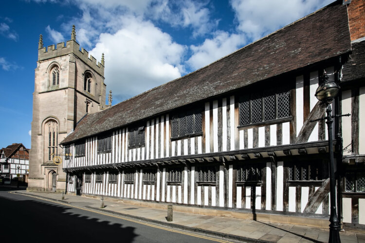 Exterior of black and white Tudor building.