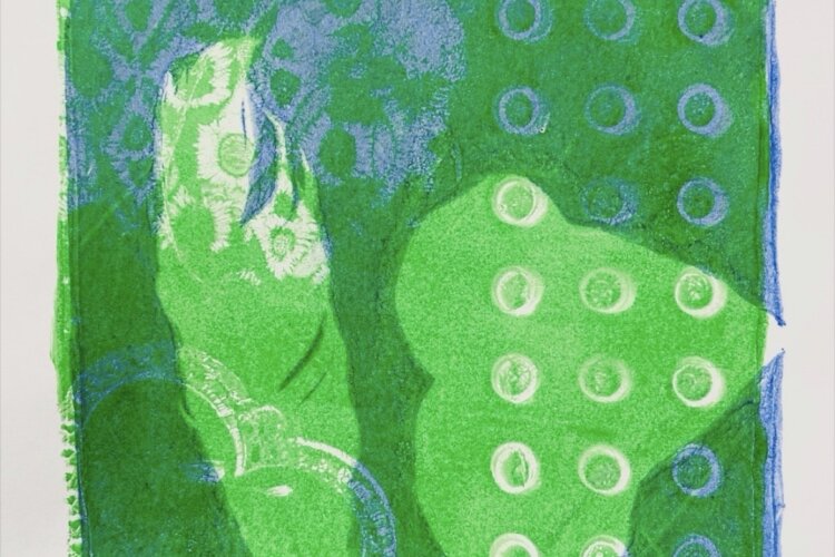 An abstract gelli print using leaves and natural materials, in green and blue ink on white paper