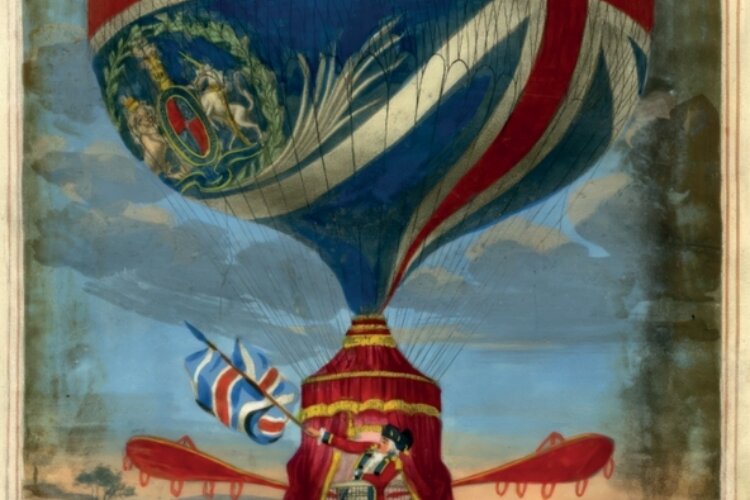 Front cover from our Spring 2026 magazine featuring a painting of Lunardi's gas balloon of 1785, which has a Union Jack flag design and the Royal Crest is inserted in one of the blue sections. Red fabric with gold trimmings covers the basket from the base of the balloon to the ground. The fabric is parted to reveal Lunardi standing in the basket waving a Union Jack flag. There are 4 red oars protruding from the basket. The backdrop is a view of the English countryside.