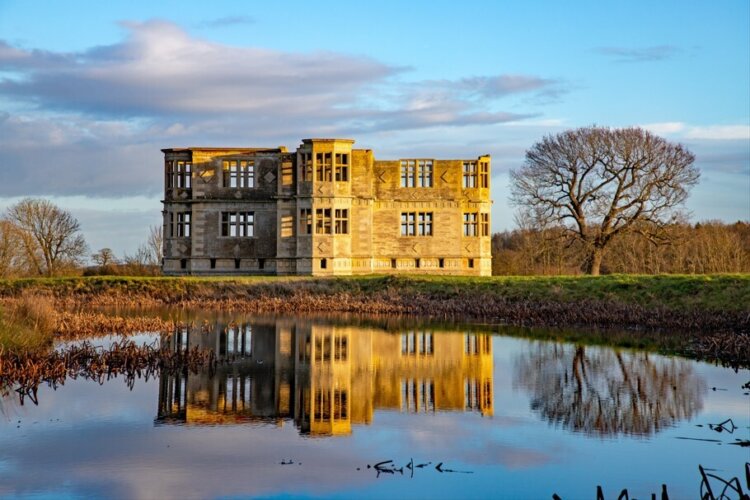 The lodge reflected in the lake at Lyveden, Northamptonshire