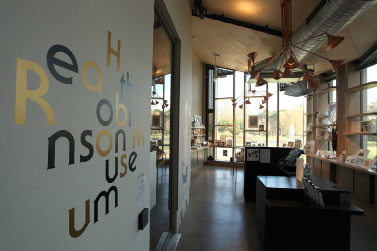 photograph of the Heath Robinson Museum shop. The Heath Robinson Museum logo is on the wall in the foreground.