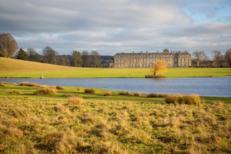 View across Upper Pond towards the mansion at Petworth House and Garden, West Sussex