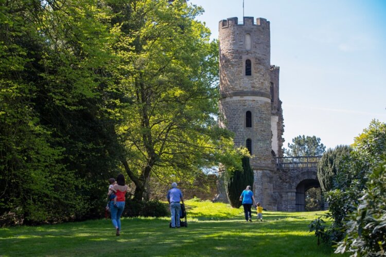 Visitors walking near the gothic folly 'Stainborough Castle' at Wentworth Castle Gardens, South Yorkshire
