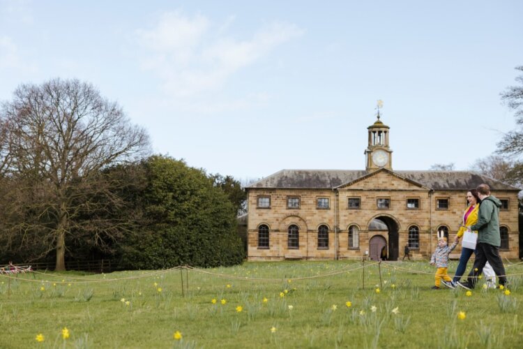 Young family entering Ormesby Hall at Easter at Ormesby Hall, North Yorkshire