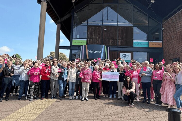 A large group of people outside the Newbury Library, all volunteers at Educafe
