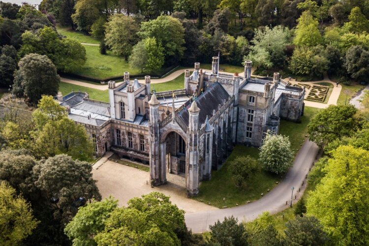 image shows ariel overview of Highcliffe Castle surrounded by grass and trees