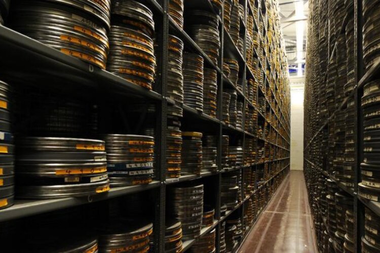 Rows of film cans in an archive storage room