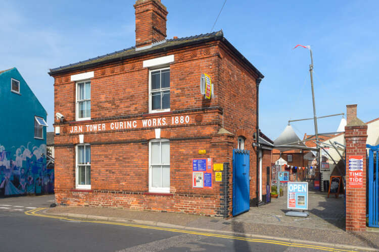 A red brick building against a blue sky backdrop (the Time and Tide Museum in Great Yarmouth)