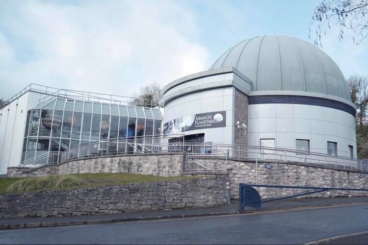 the exterior of the Armagh Observatory and Planetarium which is a big white/grey building with a dome