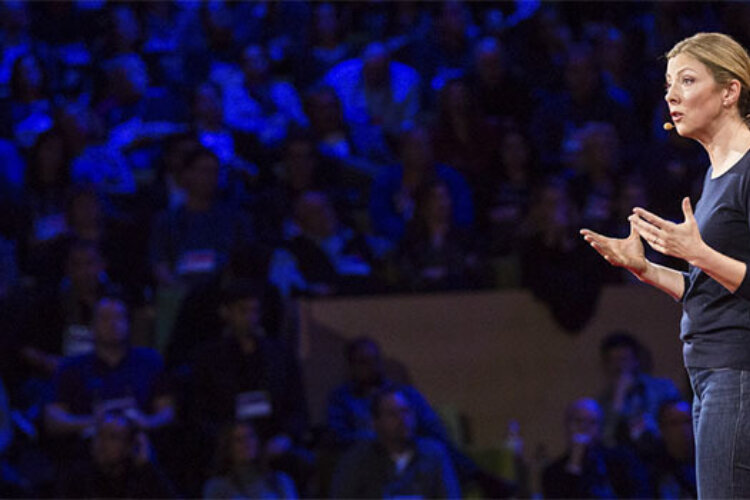 A speaker owning their voice, owning their story and owning the arena.